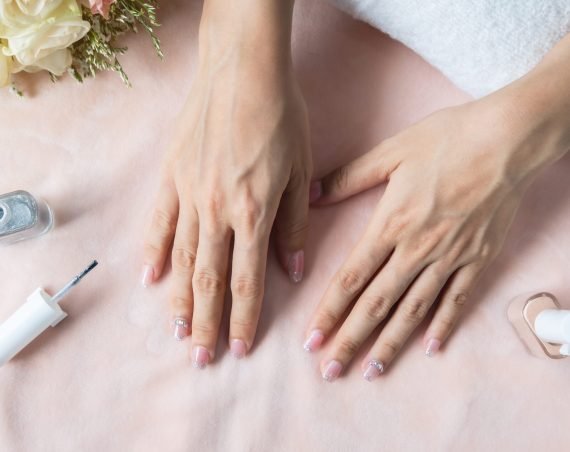 Beautiful manicure nails paint with glitter and varnish in nail salon Beautiful manicure nails paint with glitter and varnish in nail salon