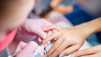 Cosmetology salon, manicure, manicurist and woman Cosmetology salon, manicure, manicurist and woman. Hands care treatment for female client in beauty shop, woman at the cosmetologist, master works with fingernails