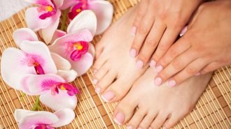 The picture of female legs and hands after pedicure and manicure.