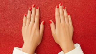 Womans hands with red minimalist nail design. Manicure, pedicure beauty salon concept Womans hands with red minimalist nail design. Manicure, pedicure beauty salon concept. New Year Christmas sale